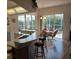 Kitchen with island seating and view of the pool in the background at 8630 Ne Coral Creek Loop, Hudson, FL 34667