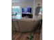 Comfortable living room with a large sectional sofa, a flat-screen TV, and access to the outdoor lanai and pool area at 8630 Ne Coral Creek Loop, Hudson, FL 34667