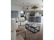 Open-concept living room with a comfortable sofa and views into the spacious kitchen at 8630 Ne Coral Creek Loop, Hudson, FL 34667