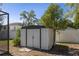 View of the backyard shed surrounded by greenery, near a screened in patio at 9032 Dorsey St, Spring Hill, FL 34608