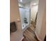 Bathroom featuring a walk-in shower and a toilet with wooden-look flooring at 9485 Hamlin Blvd # 8, Seminole, FL 33776