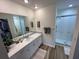 Spacious bathroom with a walk-in shower, large vanity, and plenty of counter space at 9485 Hamlin Blvd # 8, Seminole, FL 33776