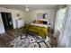 A bedroom with a ceiling fan, hardwood floors, an area rug, a large window, and a door to another room at 9485 Hamlin Blvd # 8, Seminole, FL 33776
