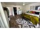 Comfortable bedroom featuring hardwood floors, an area rug, a ceiling fan, a window, and a door to another room at 9485 Hamlin Blvd # 8, Seminole, FL 33776