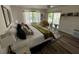 Bedroom with hardwood floors, an area rug, and a sliding glass door to a screened patio at 9485 Hamlin Blvd # 8, Seminole, FL 33776