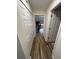 Hallway with wood floors and access to rooms, featuring a closet for storage and natural light at 9485 Hamlin Blvd # 8, Seminole, FL 33776