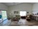 Open living room with vaulted ceilings, a ceiling fan and a sliding glass door at 9485 Hamlin Blvd # 8, Seminole, FL 33776