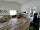 A spacious living room featuring hardwood floors, a comfortable sofa, and an open layout connecting to the kitchen at 9485 Hamlin Blvd # 8, Seminole, FL 33776