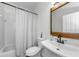 Bathroom featuring a sink vanity, a framed mirror, and a shower and tub combination at 10623 Marsha Dr, New Port Richey, FL 34655