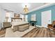 Comfortable main bedroom boasts hardwood floors, neutral color scheme, tray ceiling, and a lovely decorative light fixture at 10623 Marsha Dr, New Port Richey, FL 34655