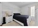Comfortable bedroom featuring a queen bed, soft carpet, white furniture, and natural light at 10623 Marsha Dr, New Port Richey, FL 34655