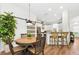 Dining area featuring table with four chairs, breakfast bar, and modern sliding glass door at 10623 Marsha Dr, New Port Richey, FL 34655