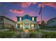 Charming two-story blue house with a white picket fence and American flag at 10623 Marsha Dr, New Port Richey, FL 34655