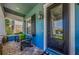 Inviting front porch with stylish seating, a modern door, and blue exterior at 10623 Marsha Dr, New Port Richey, FL 34655