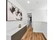 Hallway featuring modern white and gray decor, built-in storage, and view into living room at 10623 Marsha Dr, New Port Richey, FL 34655