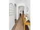Hallway featuring wood floors, a decorative window, and a view of the living room at 10623 Marsha Dr, New Port Richey, FL 34655