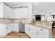 Bright kitchen with stainless steel appliances, granite countertops, and hardwood floors at 10623 Marsha Dr, New Port Richey, FL 34655