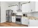 Bright kitchen featuring stainless steel appliances, white cabinets, and marble countertops at 10623 Marsha Dr, New Port Richey, FL 34655