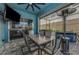 Inviting covered outdoor seating area, complete with a mounted television, heater and bar for entertaining at 10623 Marsha Dr, New Port Richey, FL 34655