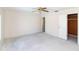 Spacious bedroom with open closet and adjacent door at 11001 Peppertree Ln, Port Richey, FL 34668