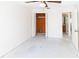 Spacious bedroom with closet with bifold doors and adjacent tiled bathroom at 11001 Peppertree Ln, Port Richey, FL 34668