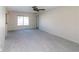 Spacious living area with a window, allowing natural light, ready for personalization and comfortable living at 11001 Peppertree Ln, Port Richey, FL 34668