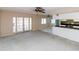 Bright living area connected to the kitchen, featuring French doors for indoor/outdoor living at 11001 Peppertree Ln, Port Richey, FL 34668