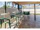 Outdoor covered patio with comfortable barstool seating at 11001 Peppertree Ln, Port Richey, FL 34668