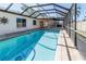 Refreshing screened-in pool with ample space for swimming at 11001 Peppertree Ln, Port Richey, FL 34668