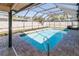 The screen-enclosed pool provides a private and refreshing escape at 11001 Peppertree Ln, Port Richey, FL 34668