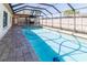 Image of refreshing screened-in pool and inviting patio area at 11001 Peppertree Ln, Port Richey, FL 34668