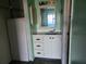Small bathroom area featuring a vanity with storage and mirror at 11130 Carriage Hill Dr # 1, Port Richey, FL 34668