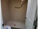 Bathroom with shower featuring beige tiles and a toilet at 11130 Carriage Hill Dr # 1, Port Richey, FL 34668