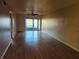 Bright living room featuring wood flooring and sliding glass doors to the back patio at 11130 Carriage Hill Dr # 1, Port Richey, FL 34668