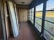 Enclosed porch area with tile flooring and scenic views of the outdoors at 11130 Carriage Hill Dr # 1, Port Richey, FL 34668