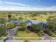 Aerial view of community clubhouse, golf course, and lake providing a beautiful recreational setting at 11339 Alden Ct, Hudson, FL 34667