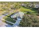 Aerial view of a well-maintained home with lush landscaping, a driveway, and a serene neighborhood setting at 11339 Alden Ct, Hudson, FL 34667