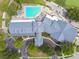 Top-down aerial view of the clubhouse, swimming pool, golf course, and surrounding landscape at 11339 Alden Ct, Hudson, FL 34667