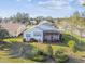 Aerial view of the home showcasing its spacious backyard, screened patio, and well-maintained landscaping at 11339 Alden Ct, Hudson, FL 34667