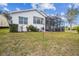 Charming home with a cozy screened patio, surrounded by lush landscaping and a well-maintained lawn at 11339 Alden Ct, Hudson, FL 34667