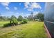 Expansive backyard with well-maintained lawn, mature trees, and lush landscaping offering privacy and space at 11339 Alden Ct, Hudson, FL 34667
