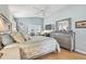 Bright bedroom featuring a ceiling fan, wood floors, dresser, and a window view at 11339 Alden Ct, Hudson, FL 34667