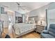 Inviting bedroom featuring a ceiling fan, wood floors, recliner and a window view at 11339 Alden Ct, Hudson, FL 34667