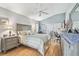 Bedroom with a ceiling fan, wood floors, dresser, and a window view at 11339 Alden Ct, Hudson, FL 34667