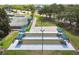 Aerial view of bocce ball courts with shaded seating areas and manicured landscaping at 11339 Alden Ct, Hudson, FL 34667