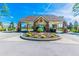 A beautifully landscaped community entrance with a covered gatehouse and well-maintained surroundings at 11339 Alden Ct, Hudson, FL 34667