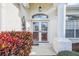 Close-up of the front door with sidelights and decorative columns at 11339 Alden Ct, Hudson, FL 34667