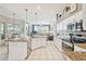 Bright kitchen with white cabinets, granite countertops, and modern stainless-steel appliances at 11339 Alden Ct, Hudson, FL 34667