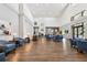 Spacious lobby with high ceilings, modern lighting, and comfortable blue armchairs arranged for gathering at 11339 Alden Ct, Hudson, FL 34667
