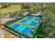 Aerial view of multiple pickleball courts, ready for recreational play and community tournaments at 11339 Alden Ct, Hudson, FL 34667